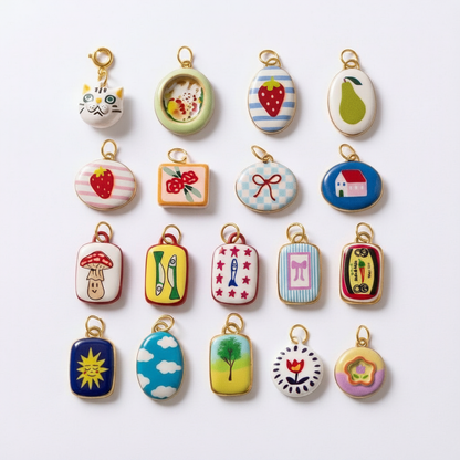 Illustrated enamel charms flat lay white background