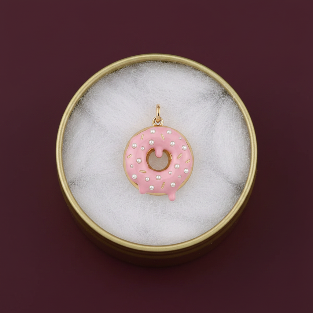 Pink donut charm in gold tin box